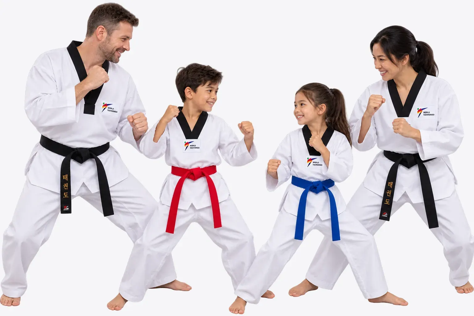 A family of four in taekwondo uniforms practise a stance together (stock photo)
