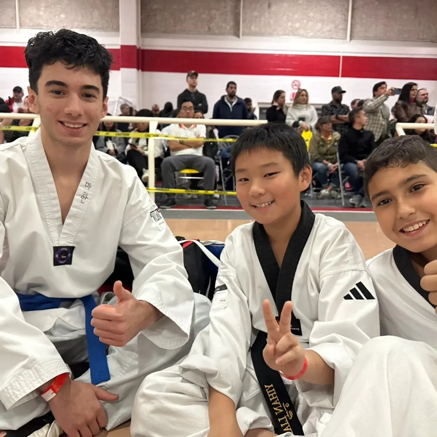 Three High Performance students smile with their medals at a tournament in Toronto