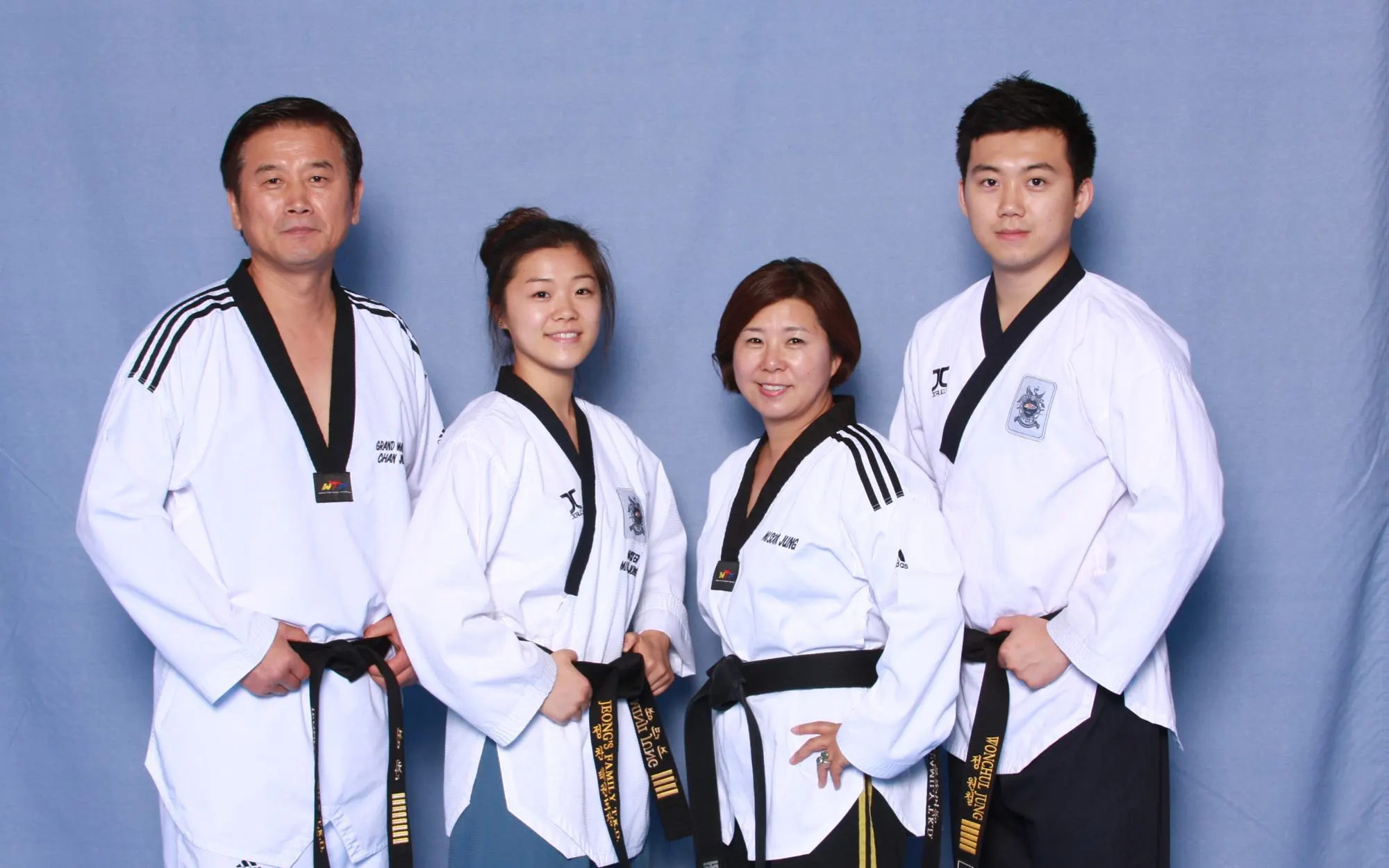The Jeong family today, in their uniforms and black belts